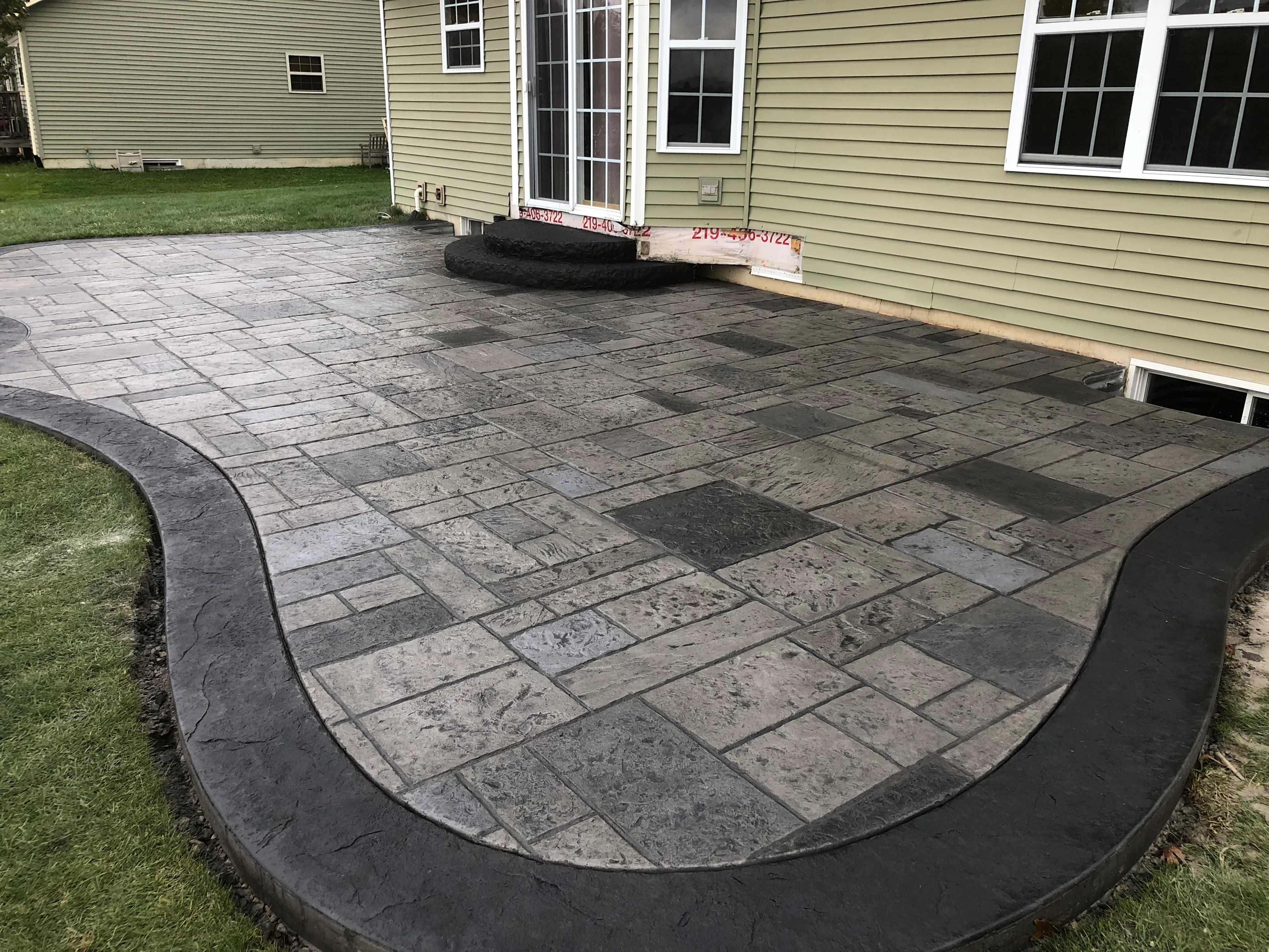 curved stamped concrete patio autumn trees lowell indiana