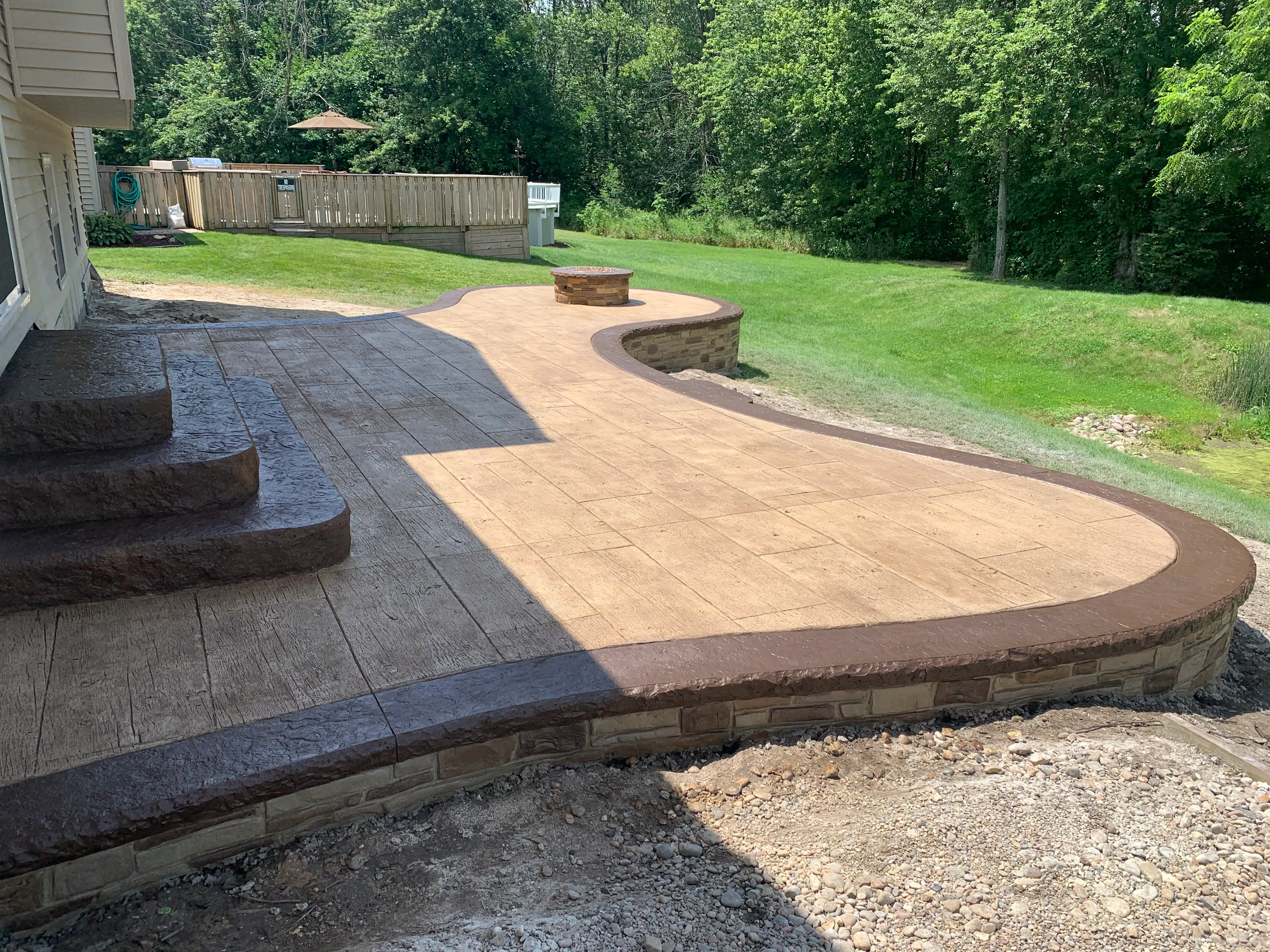 stone surround fire pit stamped concrete patio chesterton indiana