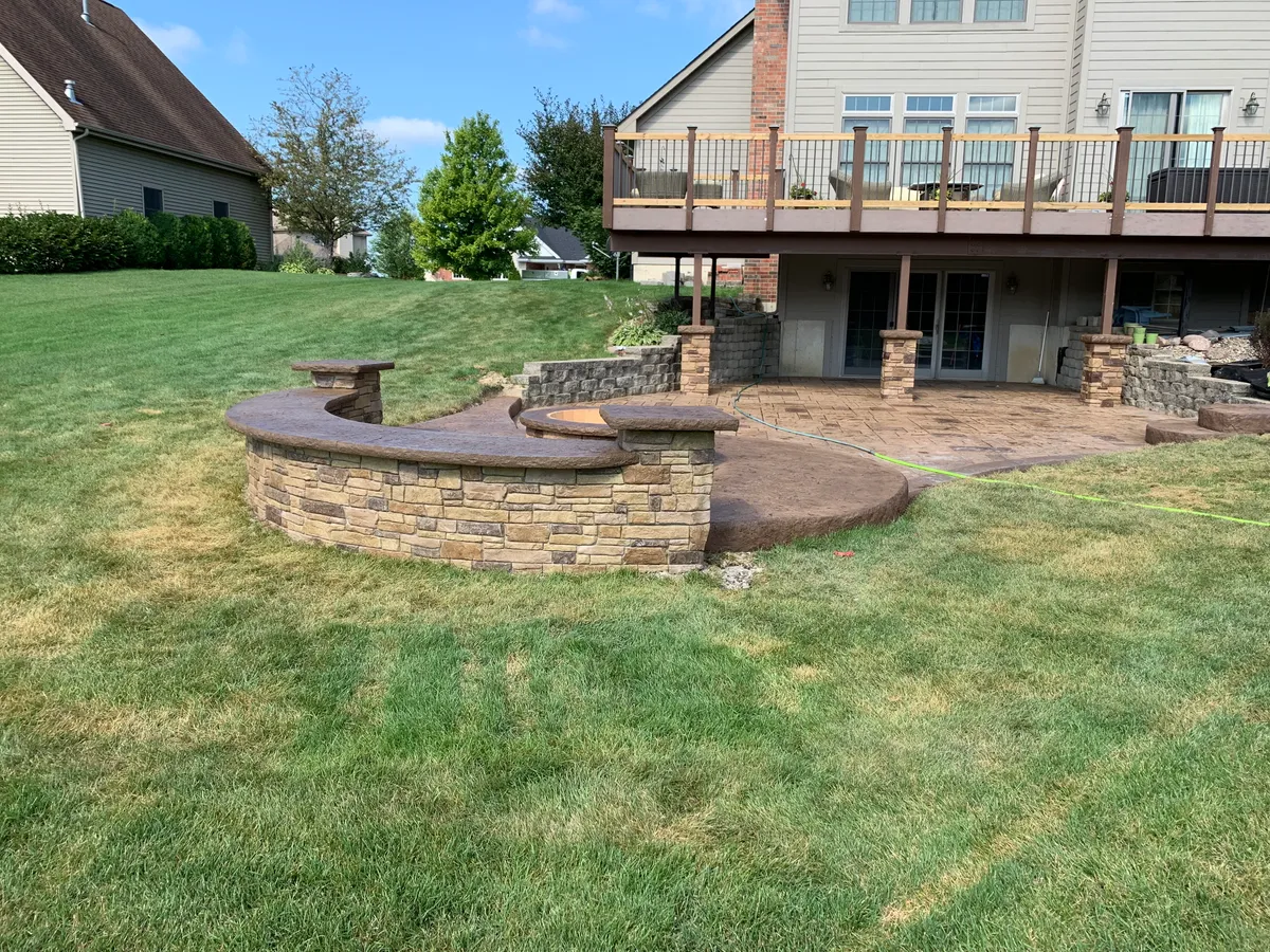 Hoosier Concrete Final Integrated concrete fire pit built flush into a stamped concrete patio in Northwest Indiana